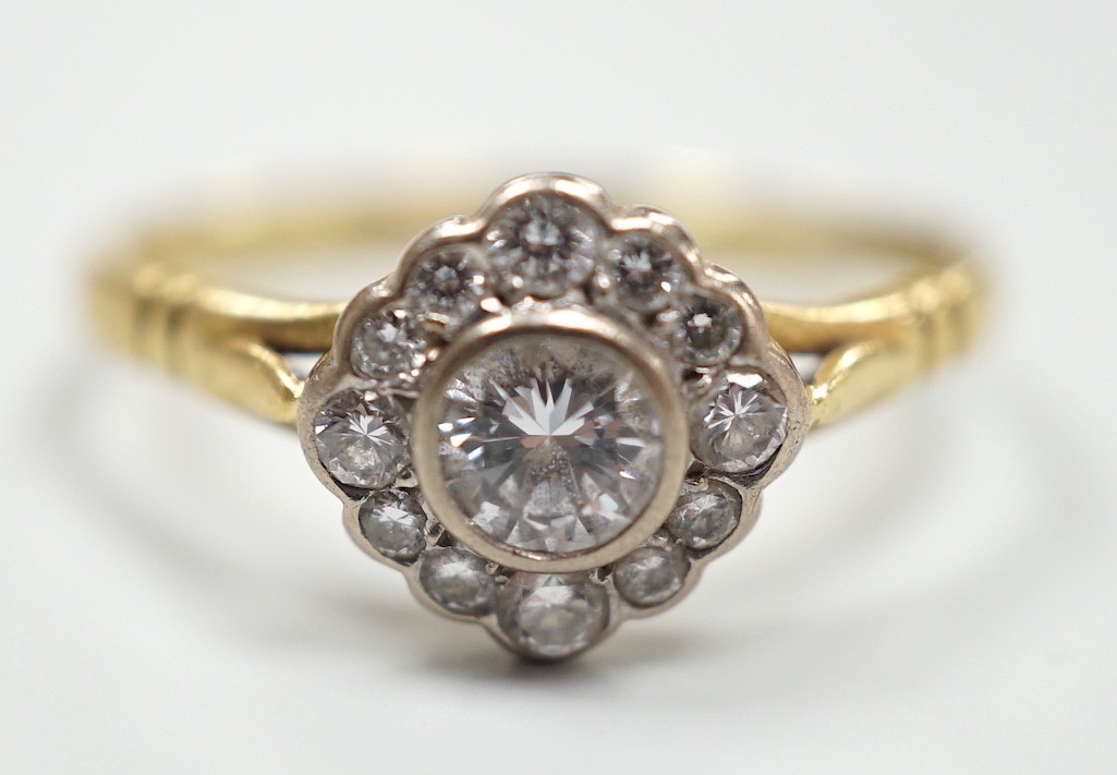 A modern 18ct gold and single stone diamond ring, with diamond set border, size S, gross weight 3.2 grams.